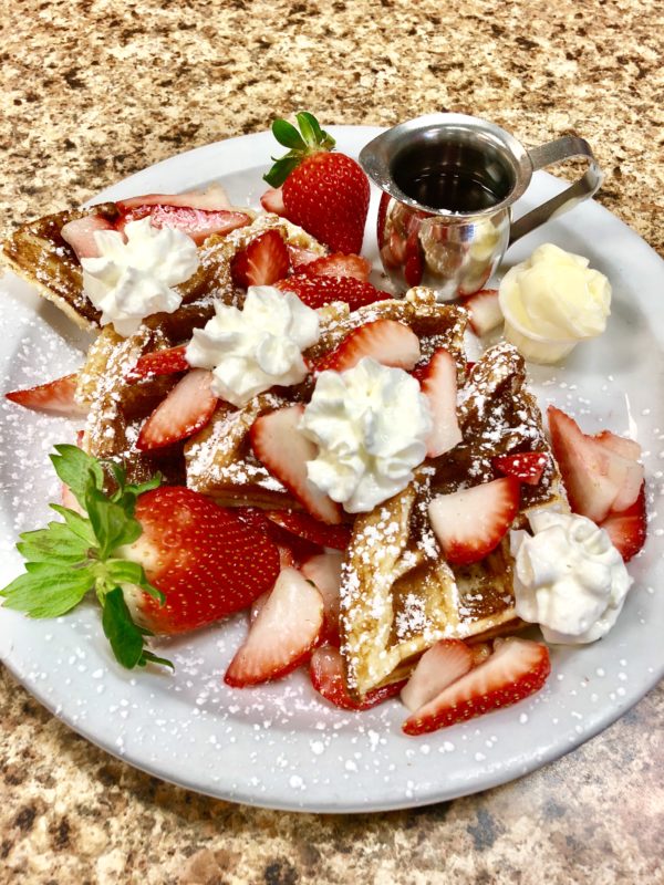 Perk Eatery Belgium Waffle topped with Fresh Strawberries and Chantilly Cream