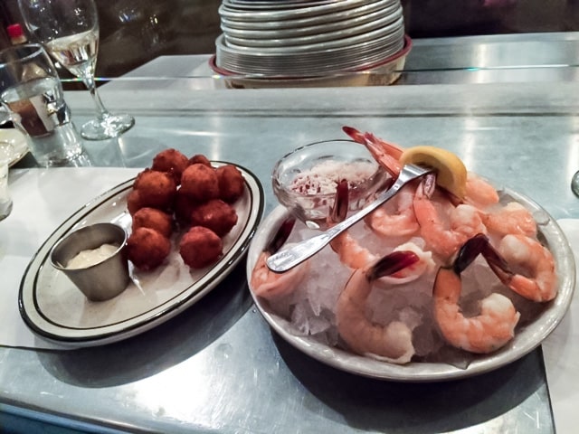 Small plates include sweet corn hush puppies and shrimp cocktail.